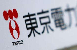 A TEPCO logo is pictured on a sign showing the way to the venue of the company's annual shareholders' meeting in Tokyo